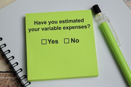 Have you estimated your variable expenses write on sticky notes isolated on Wooden Table. A person is answering question concept photo