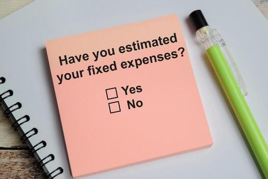 have you estimated your fixed expenses write on sticky notes isolated on Wooden Table. A person is answering question concept photo