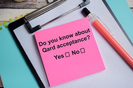 Do you know about Qard acceptance write on sticky notes isolated on Wooden Table. A person is answering question concept photo