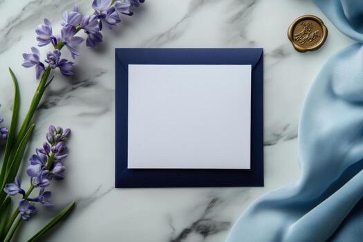 An empty white card on a marble table with purple flowers photo