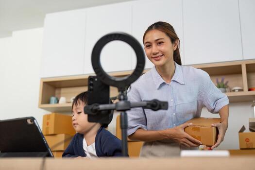Entrepreneurship. A mother prepares for a call while her child engages with a tablet. photo