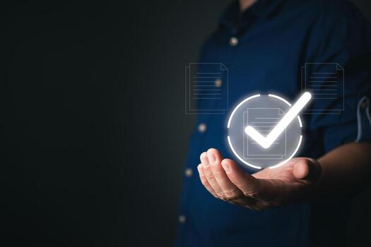 A person holds as virtual document icons with checkmarks appear, representing quality assurance, client focused services, and seamless document management in a digital workflow. photo