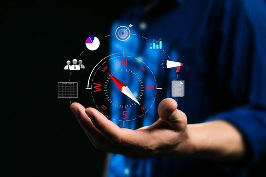 Compass for navigation, direction of business strategy to achieve the highest goal, of personnel control, scheduling and public relations, businessman set the compass to guide to success. Dark tone photo