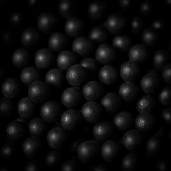 Dark Textured Orbs Forming an Abstract Pattern in Deep Shadows. photo