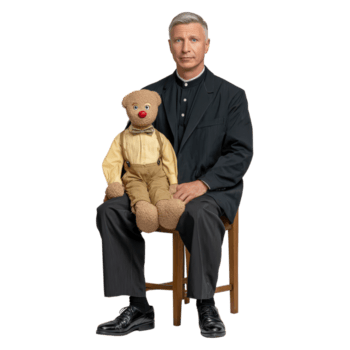 Man Sitting on Chair with Vintage Puppet in Lively Studio Setting Capturing Nostalgic Charm and Whimsy png