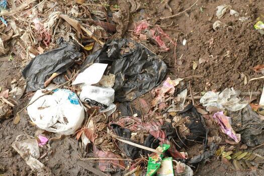 a pile of trash and garbage on the ground photo