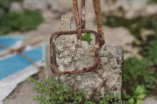 a rusty chain is attached to a rock photo
