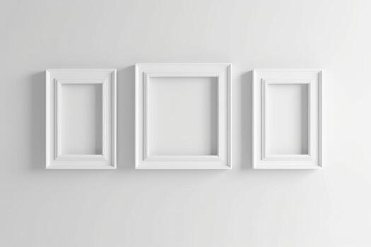Three blank white frames with copy space hanging on white wall. photo