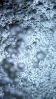 Flowing seething water with air bubbles, view from bottom to top, aeration and saturation of water with oxygen. video