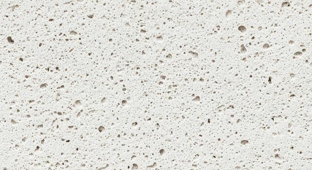 Close-up of Porous White Stone Texture with Numerous Small Holes and Cavities. photo