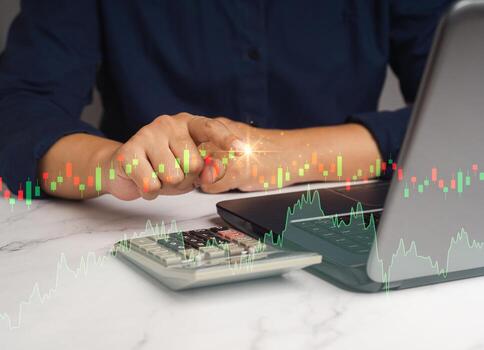 Hand of a businessman pointing to the buy button on graph stock on a virtual screen photo