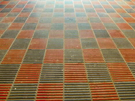 Abstract perspective shows a textured brick pattern with alternating rows in orange and gray photo