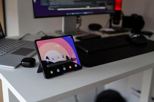 Modern Workspace with Foldable Tablet and Computer Set Up for Technology Enthusiasts and Remote Work Professionals photo