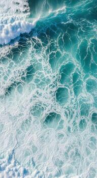 Top down view of a turquoise ocean wave with white foam photo