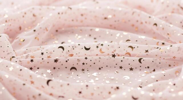 Light pink sheer fabric with gold and black stars and moons image photo