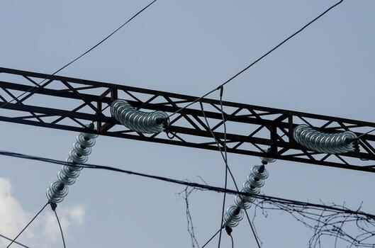 A power line with three glass insulators on it. The insulators are made of glass and are used to protect the power line from weather and other elements photo