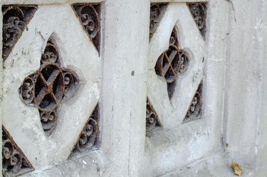 The wall has a lot of designs on it, including a diamond shape. The diamond shape is surrounded by a lot of other shapes, and it is the most prominent design on the wall photo