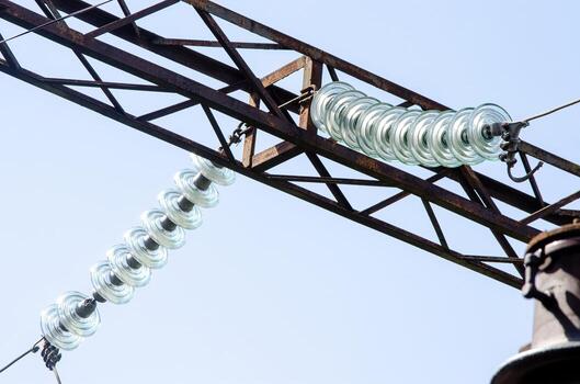 A power line with a long, twisted wire hanging from it. The wire is made of glass and is connected to a power source photo