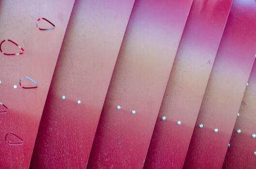 A series of pink and orange stripes with a heart in the middle. The stripes are arranged in a zigzag pattern photo