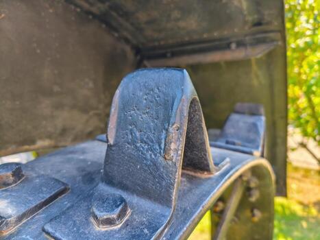 A close up of a rusted metal object with a missing bolt. The bolt is missing and the object is covered in rust. The object appears to be a piece of machinery or a tool photo