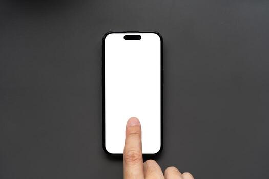 Hand Touching on center of Smartphone with Blank White Screen. finger touching the display, isolated against a dark background. Ideal for app mockups, UI presentations, and technology concepts. photo