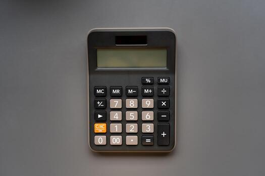 Modern Electronic Calculator on Gray Background, Top View. Suitable for business, finance, and educational use. Ideal image for illustrating office tools, accounting, or math-related concepts. photo