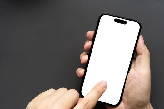 Hand Touching Smartphone with Blank White Screen on Dark Background. finger touching the display, isolated against a dark background. Ideal for app mockups, UI presentations. photo