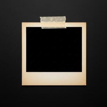 Vintage instant photo frame with tape on a dark background