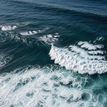 Aerial view of dark blue ocean waves crashing with white foam photo
