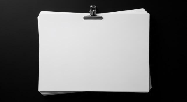 Blank white paper on a clipboard isolated on black background photo