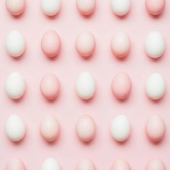 Rows of pastel pink and white easter eggs arranged on a pink background photo