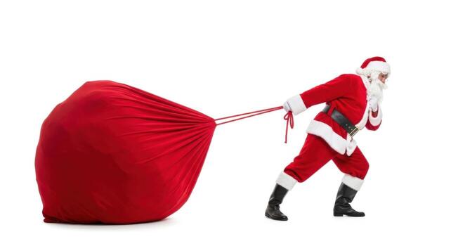 Santa claus dragging a large red sack isolated on white background photo