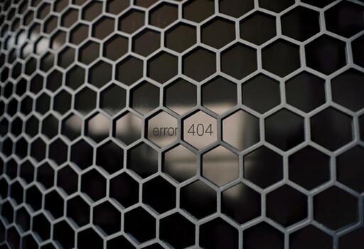 Digital glitch error 404 message behind hexagonal grid pattern photo