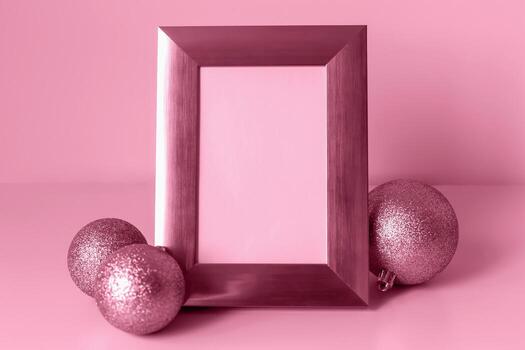 Mockup. Christmas. Decorative photo frame mockup is set against soft pink background, accompanied by glittering ornaments, creating festive atmosphere perfect for design projects and holiday themes