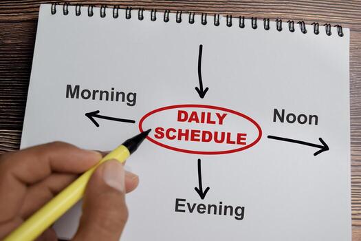 Concept of Daily schedule write on book with keywords isolated on Wooden Table. photo