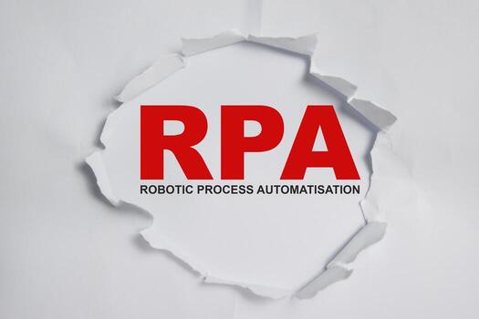 RPA - robotic Process Automatisation Text written in torn paper photo