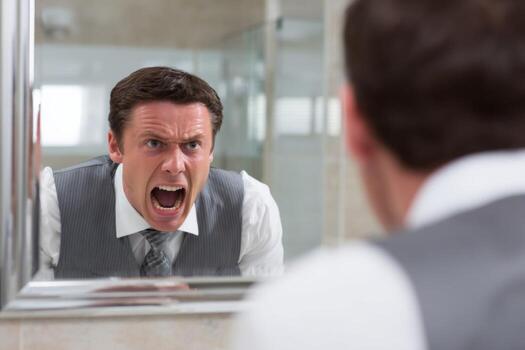 A man in a suit is looking at himself in the mirror photo
