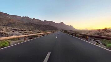 A road with mountains in the background at sunset video