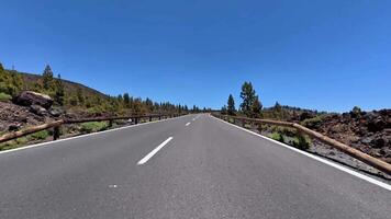 A stunningly picturesque view of a winding mountain road surrounded by lush greenery and vibrant blue skies above video