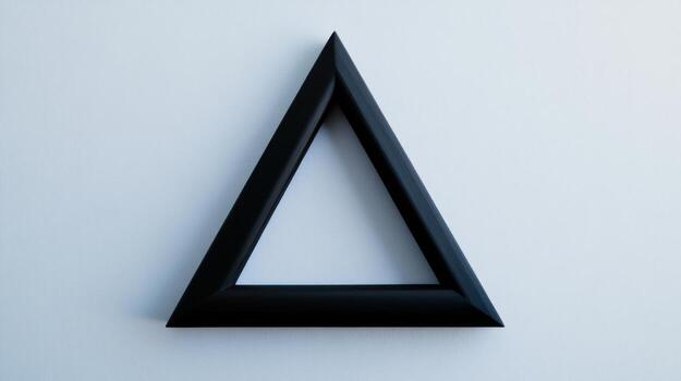 A black triangle on a white wall photo