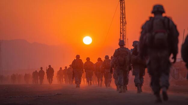 A group of soldiers are walking in a desert at sunset photo