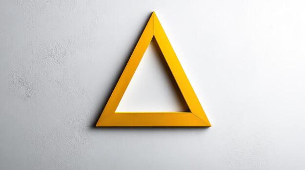 A yellow triangle on a white wall photo