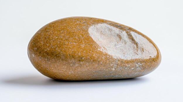 A smooth brown stone is displayed against a light surface, featuring a distinct white patch that highlights its natural texture and unique shape, evoking curiosity photo