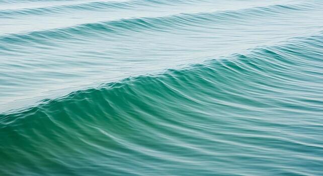 A wave is seen in the ocean with a person on a surfboard photo