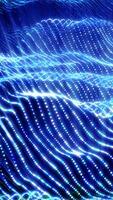Flowing blue waves made of countless glowing dots creating a luminous and dynamic abstract pattern video