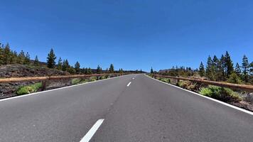 A beautiful road with lush greenery and a bright blue sky, perfect for unforgettable scenic drives and explorations photo