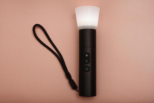 A flashlight with adjustable beam. Multi-mode torch for professionals. Photographed on a light grey background. photo