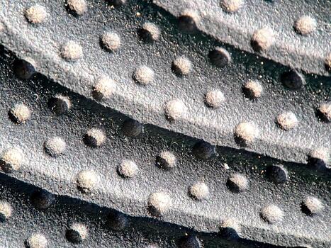 Textured surface with rounded bumps and shadows creates a dynamic, abstract pattern. photo