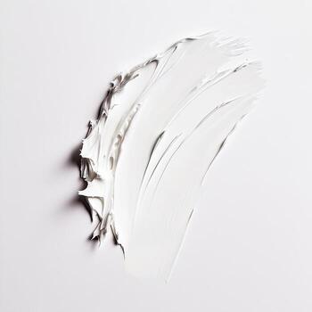 Smooth strokes of thick white cream texture on a clean surface create an abstract element photo