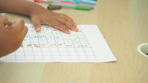 Child solving a colorful puzzle at a table photo